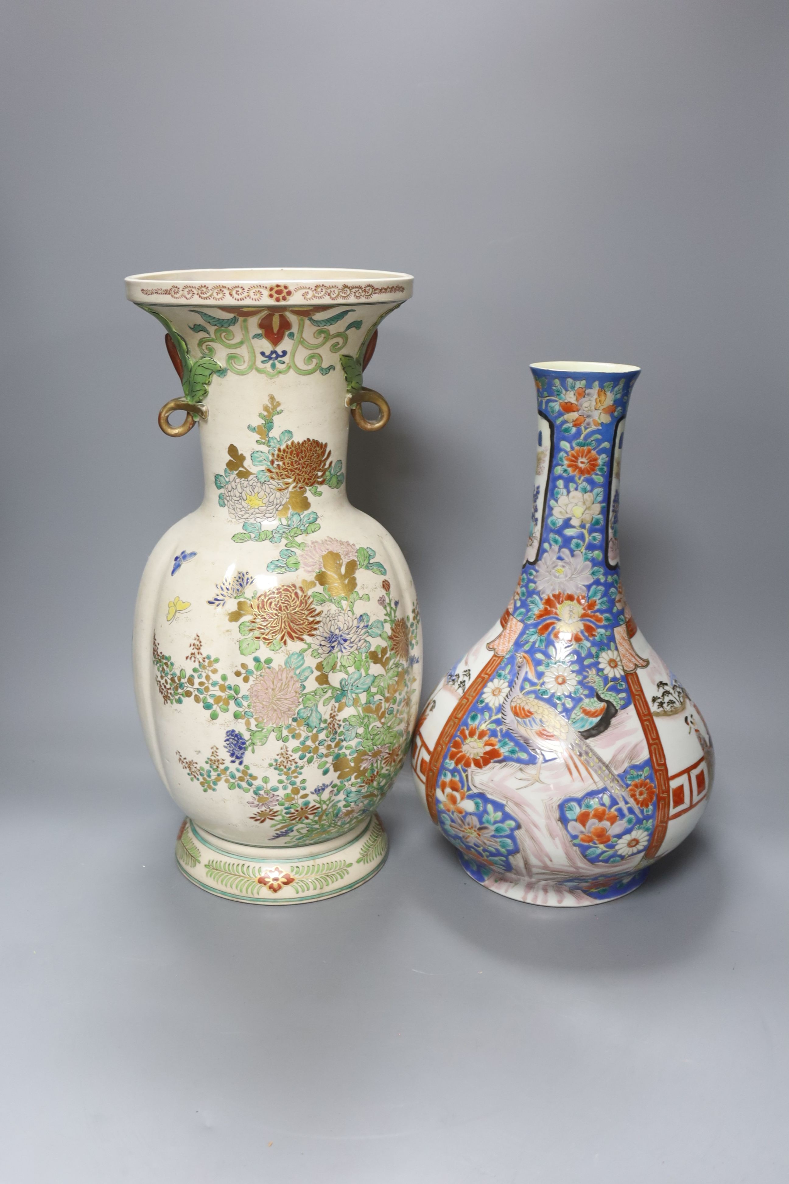 A Japanese porcelain bottle vase and a large Satsuma pottery vase (restoration) 39cm (2)